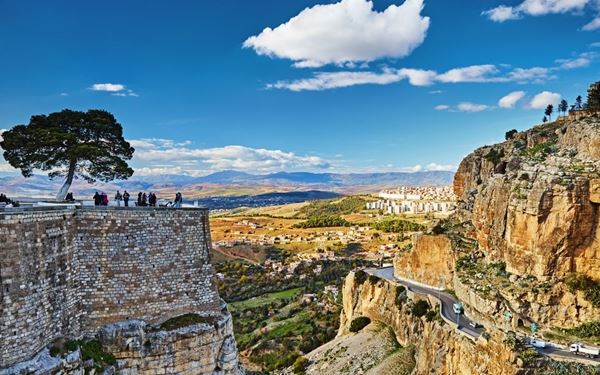 Constantine, the "City of Bridges," is dramatically perched on cliffs split by a deep gorge of the Rhumel River. The city is connected by several historic and spectacular suspension bridges that offer dizzying views. Its rich history spans from Numidian times to the French colonial era, making it one of the most visually stunning and historic urban centers in North Africa.
