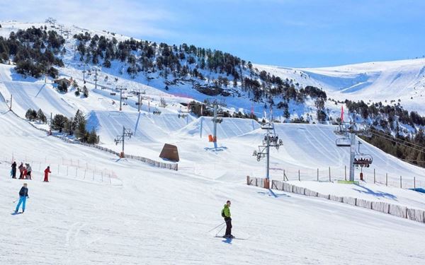 Grandvalira is the largest ski resort in the Pyrenees and one of the most popular in Europe. Spanning across several sectors, it offers hundreds of kilometers of slopes for all levels, as well as snowshoeing and dog sledding. In summer, the area transforms into a lush green playground for mountain biking and golf, providing year-round outdoor adventure.