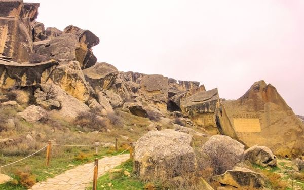 Gobustan is famous for its extraordinary collection of over 6,000 ancient rock engravings that date back up to 40,000 years. The park also features unique mud volcanoes, a rare natural phenomenon. This prehistoric site provides fascinating insights into the lives of early humans and is set against a dramatic, arid landscape near the Caspian Sea.