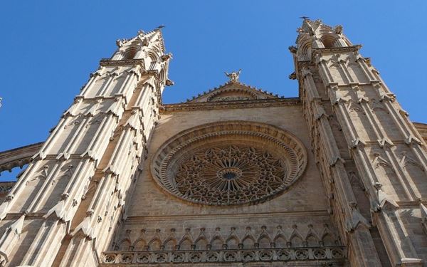 Located in Mallorca, La Seu is a magnificent Gothic cathedral famous for its massive rose window and its spectacular reflection in the Parc de la Mar. Designed with unique Catalan influences, it features interior work by Antoni Gaudí. Standing as the most iconic landmark of Palma, the cathedral represents the islands' rich architectural heritage and offers stunning views of the Mediterranean Sea.