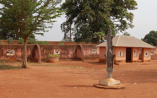 The Royal Palaces of Abomey are a UNESCO World Heritage site consisting of a complex of earthen structures built by the Fon people. These palaces were the center of power for the Kingdom of Dahomey. Visitors can explore the historic throne rooms, funeral outbuildings, and ornate bas-reliefs that tell the stories of powerful kings and the famous Dahomey Amazons, the all-female military regiment.