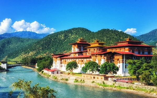 Punakha Dzong, known as the "Palace of Great Happiness," is arguably the most beautiful fortress in Bhutan. Situated at the confluence of the Pho Chhu and Mo Chhu rivers, its majestic whitewashed walls and golden roofs create a stunning reflection in the water. It serves as the winter residence of the central monastic body and is a masterpiece of traditional Bhutanese architecture.