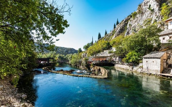 Perched at the source of the Buna River, the Blagaj Tekke is a 600-year-old Dervish monastery built into a massive cliff. The combination of the white historic house and the stunning turquoise river emerging from a cave creates a mystical and serene atmosphere. It is a place of peace and spiritual reflection, representing the deep Sufi traditions and the natural beauty of Herzegovina.