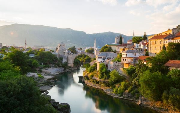 The Stari Most, or Old Bridge, is a 16th-century Ottoman bridge in the city of Mostar that crosses the Neretva River. It is a symbol of reconciliation and cultural diversity. Visitors can watch local divers jump from the bridge into the emerald waters below. The surrounding cobblestone streets of the Old Bazaar offer a rich blend of history, crafts, and traditional cuisine.