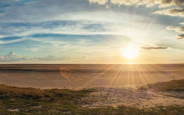 The Makgadikgadi Pans are among the largest salt flats in the world, covering a vast area of the Kalahari Desert. This otherworldly landscape is stark and silent during the dry season but transforms into a lush wetland during the rains, attracting thousands of flamingos and zebras. It is a place of extreme beauty and solitude, offering unique star-gazing and quad-biking adventures.