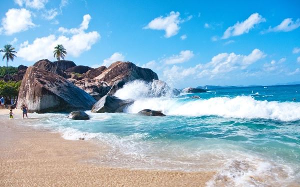 The Baths is a unique geological formation on the island of Virgin Gorda, featuring giant granite boulders that form a series of spectacular sea caves and tidal pools. Visitors can swim through the turquoise grottos and sunbathe on the pristine white sand. It is a natural playground and one of the most famous and beautiful destinations in the entire Caribbean.