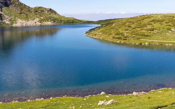 The Seven Rila Lakes are a group of glacial lakes situated high in the Rila Mountains. Each lake is named after its characteristic shape, such as "The Kidney" or "The Eye." A popular hiking destination, the area offers breathtaking alpine scenery and crystal-clear waters. It is a place of natural wonder and spiritual significance, attracting nature lovers and hikers seeking mountain peace.