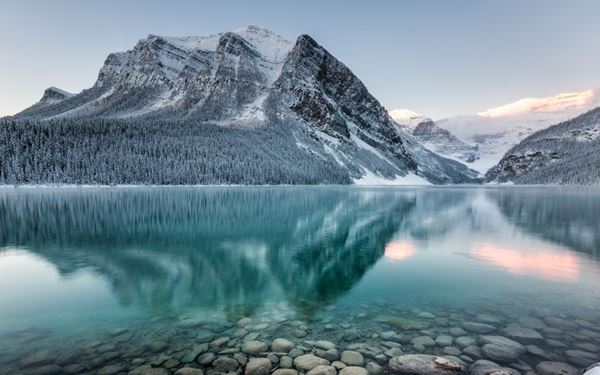 Located in the heart of the Canadian Rockies, Banff is Canada's oldest national park, famous for its turquoise glacial lakes and jagged mountain peaks. Visitors can explore Lake Louise, drive the scenic Icefields Parkway, or enjoy the hot springs. It is a world-class destination for hiking, skiing, and wildlife viewing, offering some of the most dramatic landscapes in North America.