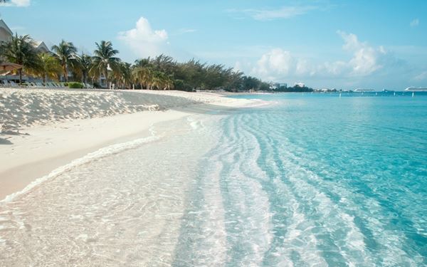 Seven Mile Beach is a long crescent of coral-sand beach on the western end of Grand Cayman. Known for its sparkling waters and coral sands, it is a public beach that hosts many of the island's luxury resorts. Whether you want to try water sports or simply relax under a palm tree, this beach epitomizes the ultimate Caribbean paradise.