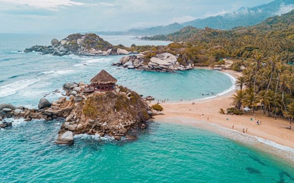 Located on the Caribbean coast, Tayrona National Park is where the Sierra Nevada de Santa Marta mountains meet the sea. It features stunning palm-fringed beaches, clear lagoons, and lush tropical jungles. Visitors can hike through the forest to reach Cabo San Juan, offering a perfect blend of adventure and natural tropical beauty.