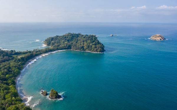 Manuel Antonio is one of the most popular national parks in Costa Rica, known for its beautiful white-sand beaches and rich biodiversity. Visitors can easily spot capuchin monkeys, sloths, and colorful toucans while hiking through the rainforest trails. It provides a quintessential Costa Rican experience of "Pura Vida" in a stunning coastal setting.