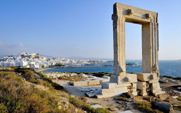 The Portara, or the Great Door, is a massive marble gateway of an unfinished temple dedicated to Apollo, standing on the islet of Palatia. It is the most recognizable landmark of Naxos and offers a stunning view of the harbor and the sea. Visiting at sunset provides a mystical experience, as the ancient monument is silhouetted against the golden sky, symbolizing the rich classical heritage of the Cyclades.