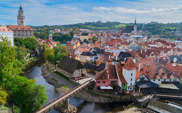 Cesky Krumlov is a fairytale town in Southern Bohemia, dominated by its massive castle and red-roofed buildings. The town is built around a sharp bend in the Vltava River and is a UNESCO World Heritage site. Its medieval charm, Renaissance architecture, and lush surroundings make it a perfect destination for those seeking a romantic and historical escape.