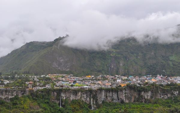 Known as the "Gateway to the Amazon," Baños is famous for its natural hot springs, thunderous waterfalls like Pailón del Diablo, and extreme sports. Visitors can ride the "Swing at the End of the World" for a thrilling view of the Tungurahua Volcano. It is a hub for relaxation and adventure, blending geothermal beauty with lush cloud forests and a lively, traveler-friendly atmosphere.