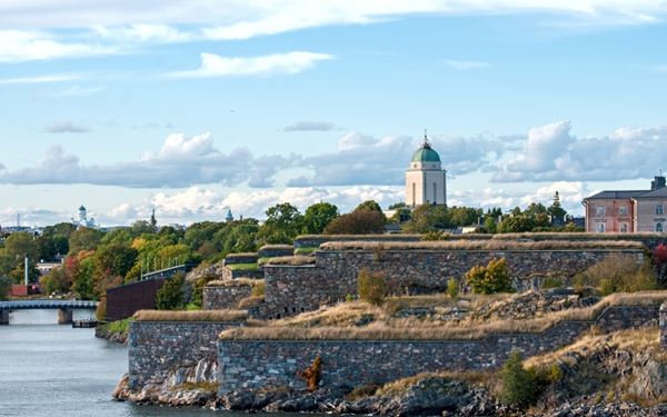 Suomenlinna is a sea fortress built on six islands off the coast of Helsinki and is a UNESCO World Heritage site. Originally constructed in the 18th century, it now houses museums, artist studios, and parks. It is a popular destination for both history buffs and picnickers, offering a unique look at military architecture and stunning views of the Baltic Sea and the city's skyline.