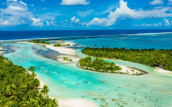 Tahiti is the largest island in French Polynesia, known for its black-sand beaches, cascading waterfalls, and vibrant Papeete market. It serves as the cultural heart of the islands, offering a blend of Polynesian tradition and French influence. Visitors can explore lush interior valleys or enjoy world-class surfing at the legendary Teahupo'o break.