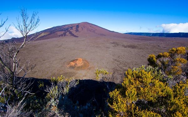 Piton de la Fournaise is one of the world's most active volcanoes and a centerpiece of Reunion Island. Visitors can hike across its lunar-like caldera to witness smoking vents and ancient lava flows. The dramatic, rugged terrain and the constant geological activity make it a must-visit for adventure seekers and nature lovers in the Indian Ocean.