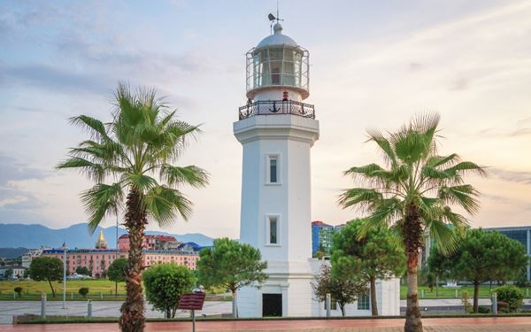 Batumi is a vibrant seaside city on the Black Sea coast, known for its modern architecture and its long, scenic boulevard. The boulevard is lined with parks, palm trees, and unique sculptures like the "Ali and Nino" moving statue. It offers a lively atmosphere with beach clubs and dancing fountains, representing the modern, cosmopolitan side of Georgia's growing tourism industry.