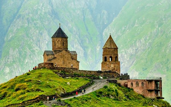 Perched on a hill at the foot of Mount Kazbek, the Gergeti Trinity Church is one of Georgia's most iconic and spiritual landmarks. The views of the surrounding Caucasus Mountains are breathtaking, especially when the clouds clear to reveal the snow-capped peak. It is a must-visit for hikers and photographers, symbolizing the rugged beauty and deep-rooted Orthodox faith of the Georgian highlands.