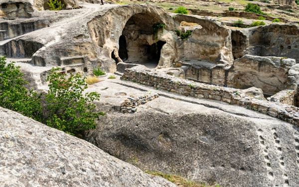 Uplistsikhe is an ancient rock-hewn city that dates back to the Early Iron Age. It features a fascinating complex of structures, including streets, temples, and a theater, all carved into the sandstone cliffs. Walking through this "Lord's Fortress" reveals layers of history from pagan times to the Christian era, offering a unique and archaeological journey along the historic Silk Road.