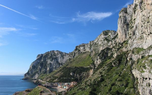 The Rock of Gibraltar is a massive limestone monolith famous for its intricate cave systems and the resident Barbary macaques, Europe's only wild monkeys. Visitors can take a cable car to the top for stunning views across the Mediterranean and over to the coast of Africa. It is a unique British territory with a rich military history and natural wonder.
