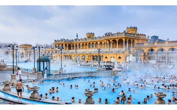 The Széchenyi Thermal Bath in Budapest is one of the largest medicinal bath complexes in Europe, housed in a beautiful Neo-Baroque building. It features grand outdoor and indoor pools fed by natural hot springs. Visiting the baths is a quintessential Hungarian experience, offering a mix of relaxation, social interaction, and stunning architecture in the heart of the city's City Park.