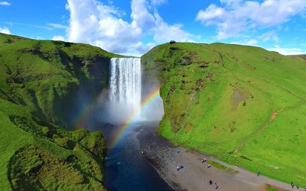 Skógafoss is one of Iceland’s largest and most impressive waterfalls, with a drop of 60 meters and a constant mist that often creates double rainbows. Visitors can walk right up to the base or climb a steep staircase for a view from the top. It is a powerful display of nature’s beauty and serves as the starting point for the famous Fimmvörðuháls hiking trail into the highlands.