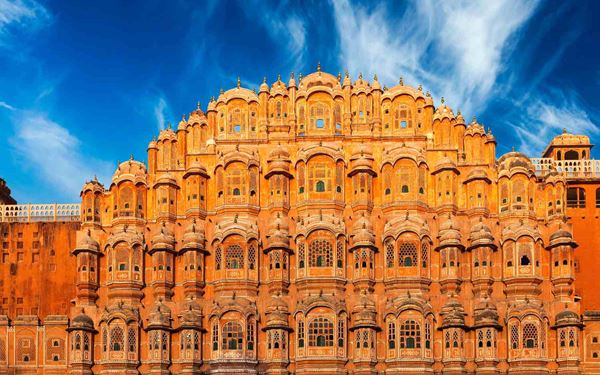 Jaipur, the "Pink City," is famous for its grand palaces and forts, with the Hawa Mahal (Palace of Winds) being its most iconic landmark. Built with pink sandstone, its unique honeycombed facade allowed royal ladies to observe street life unseen. The city is a vibrant center for crafts and history, reflecting the regal splendor of Rajasthan and the rich architectural heritage of the Rajputs.