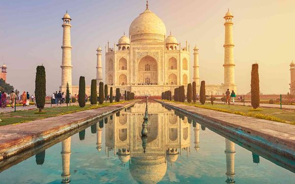 The Taj Mahal in Agra is a breathtaking white marble mausoleum built by Emperor Shah Jahan in memory of his beloved wife. Recognized as one of the New Seven Wonders of the World, its perfect symmetry and intricate floral carvings are unparalleled. It stands as the ultimate monument to love and the pinnacle of Mughal architectural brilliance.