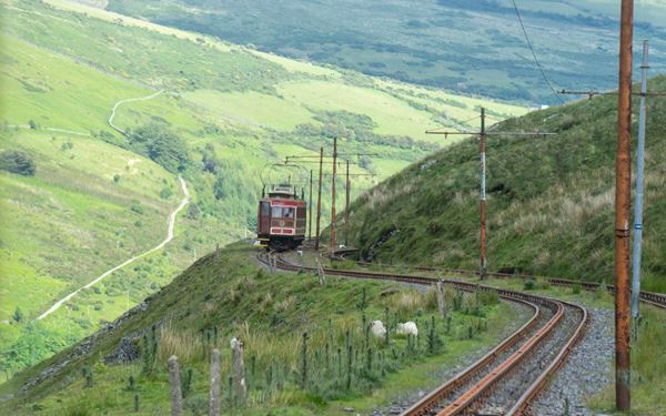 Snaefell is the highest point on the Isle of Man, and according to legend, you can see "six kingdoms" from its summit: Mann, Scotland, England, Ireland, Wales, and Heaven. Visitors can reach the peak via the Snaefell Mountain Railway, a unique Victorian electric tramway. It offers the best panoramic views of the entire island, showcasing its rugged hills and beautiful coastline.