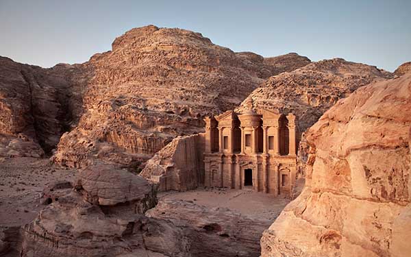 Petra, the "Rose City," is an ancient archaeological wonder carved directly into red sandstone cliffs. Famous for the stunning Treasury (Al-Khazneh) and the Monastery, it was the capital of the Nabataean Kingdom. Walking through the narrow Siq gorge to reveal the ancient city is a bucket-list experience that showcases extraordinary human craftsmanship.