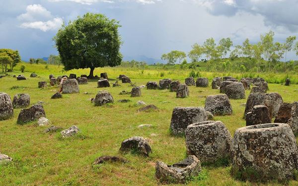 The Plain of Jars is a mysterious archaeological site featuring thousands of giant stone jars scattered across the Xiangkhoang Plateau. Dating back over 2,000 years, the jars were likely used in ancient burial rituals. Exploring this unique landscape offers a fascinating and eerie look into a lost Iron Age civilization, making it one of the most significant and enigmatic historic sites in Southeast Asia.
