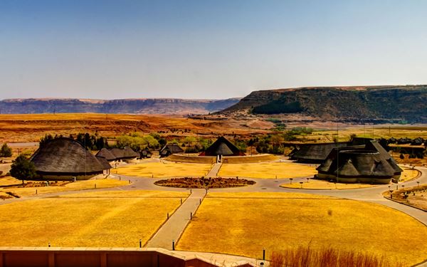 Thaba Bosiu is a sandstone plateau and the spiritual heart of the Basotho nation. It served as a mountain fortress for King Moshoeshoe I, the founder of Lesotho, and remained unconquered by enemies. The site features the graves of Basotho royalty and traditional dwellings. Climbing the plateau provides a deep connection to the history, resilience, and identity of the "Kingdom in the Sky."
