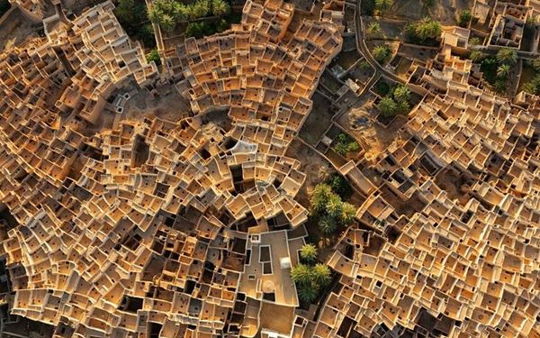 Known as the "Pearl of the Desert," Ghadames is a stunning oasis town famous for its unique Saharan architecture. The houses are interconnected, with rooftops reserved for women and covered ground-level walkways providing shade from the desert heat. This UNESCO World Heritage site is a masterpiece of environmental adaptation, reflecting the rich cultural and social history of the Berber people.