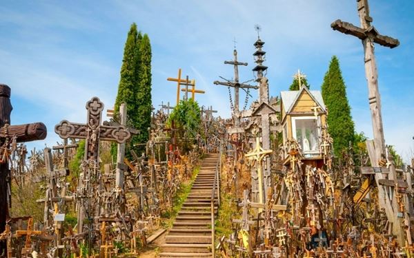The Hill of Crosses is a powerful pilgrimage site featuring over 100,000 crosses of all sizes left by people from around the world. It is a symbol of Lithuania's national identity, faith, and peaceful resistance during difficult times. Walking through the narrow paths surrounded by thousands of crosses and rosaries is a deeply moving and unique spiritual experience that captures the country's resilient spirit.