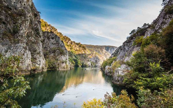 Matka Canyon is a spectacular natural gorge located near Skopje, featuring an emerald-green lake and several hidden medieval monasteries. It is a paradise for outdoor enthusiasts, offering activities like kayaking, hiking, and exploring deep caves like Vrelo. The stunning vertical cliffs and rich biodiversity make it one of the most popular and scenic nature retreats in the country.