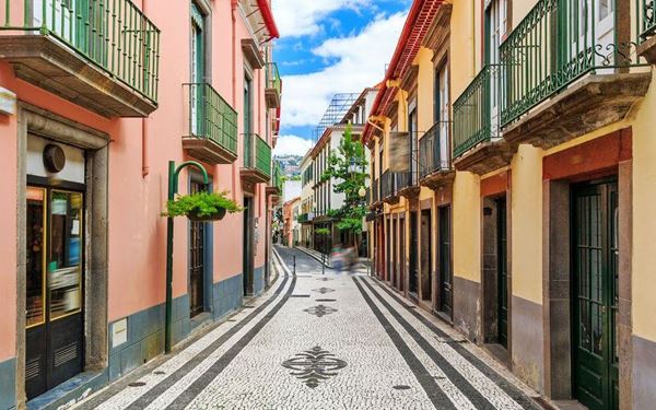 Funchal’s Old Town (Zona Velha) is a charming district known for its "Painted Doors" art project and narrow cobblestone streets. Visitors can explore the historic cathedral, vibrant local markets like Mercado dos Lavradores, and enjoy traditional Madeiran wine. The area combines historic charm with a lively atmosphere of seaside cafes and restaurants, reflecting the island's rich maritime history.