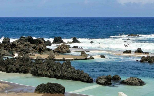 The natural volcanic pools of Porto Moniz are formed by ancient lava flows and filled by the crystal-clear waters of the Atlantic Ocean. These unique saltwater swimming holes offer a safe and stunning way to experience the sea. Surrounded by dramatic coastal views and crashing waves, they are a highlight of the island’s northern coast and a testament to Madeira’s volcanic origins.