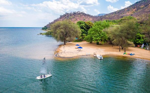 Lake Malawi is known as the "Lake of Stars" and is a UNESCO World Heritage site famous for its hundreds of species of colorful cichlid fish. The park offers incredible opportunities for snorkeling, kayaking, and scuba diving in clear, calm waters. Surrounded by lush hills and golden beaches, it is a peaceful sanctuary that provides a unique freshwater marine experience in the heart of Africa.