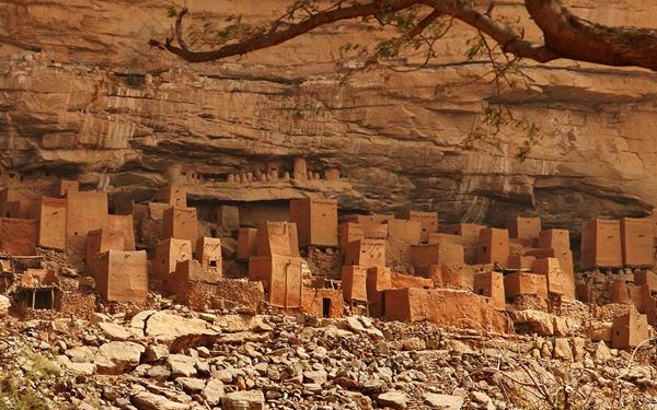 Dogon Country is a breathtaking landscape of sandstone cliffs and plateaus home to the Dogon people. Their unique villages, featuring cliff-side granaries and "togu na" meeting houses, are famous for their intricate wood carvings and masked dances. It is a place of deep spiritual traditions and ancient astronomical knowledge, offering a profound look into one of Africa's most fascinating cultures.