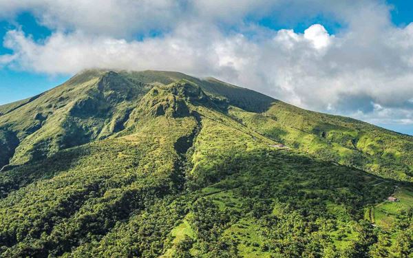 Mount Pelée is an active volcano famous for its catastrophic eruption in 1902. Today, it is a popular destination for hikers, offering challenging trails that lead to the summit through tropical forests and cloud-covered slopes. Reaching the top provides breathtaking views of the Caribbean Sea and the ruins of Saint-Pierre, serving as a powerful reminder of the island's dramatic volcanic landscape.