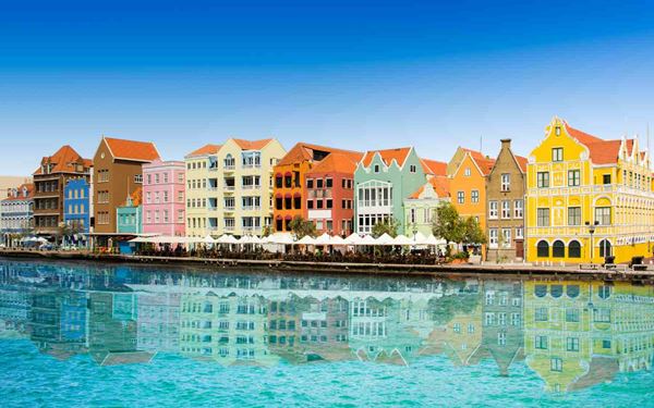 Willemstad, the capital of Curaçao, is famous for its vibrant Punda district, where colonial buildings are painted in a kaleidoscope of pastel colors. The Queen Emma Bridge, a floating pontoon bridge, connects the two sides of the city over the harbor. This UNESCO site reflects a unique blend of Dutch and Caribbean influences, offering a lively atmosphere of museums, markets, and history.