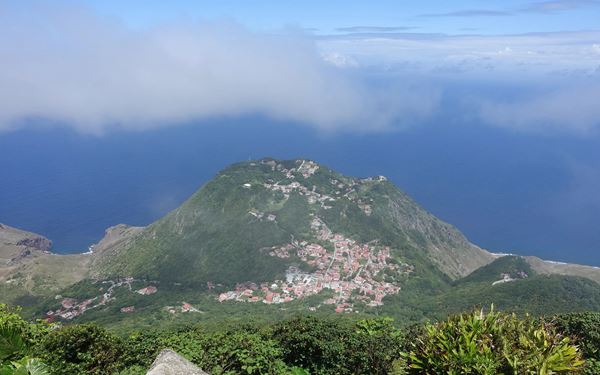 Saba, known as the "Unspoiled Queen," is home to Mount Scenery, a dormant volcano that is the highest point in the Kingdom of the Netherlands. Hiking the 1,064 steps to the summit leads through a mystical cloud forest with breathtaking views of neighboring islands. The island’s rugged terrain and lack of mass tourism provide a tranquil and authentic Caribbean experience for nature lovers.