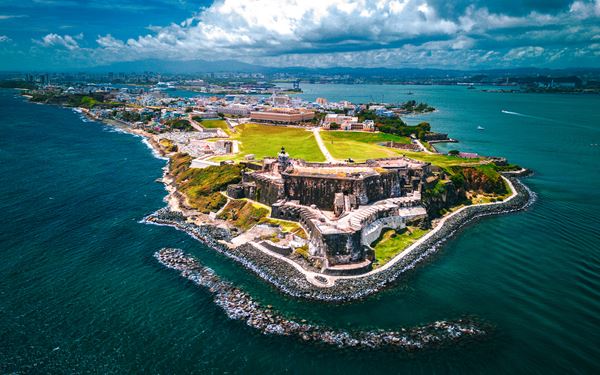 Old San Juan is a historic district known for its brightly colored Spanish colonial buildings and blue cobblestone streets. It is home to massive forts like Castillo San Felipe del Morro, which offers stunning ocean views. Walking through the walled city reveals historic plazas, vibrant street art, and a rich cultural heritage that blends Spanish, African, and Taino influences.