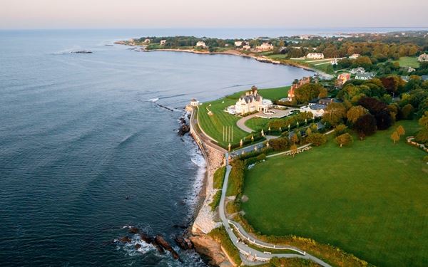 The Cliff Walk in Newport is a world-famous 3.5-mile trail that combines the natural beauty of the rocky shoreline with the architectural grandeur of Gilded Age mansions. Visitors can enjoy panoramic views of the Atlantic Ocean on one side and the sprawling lawns of historic estates on the other. It is a unique and scenic public walk that highlights the elegance and coastline of the state.