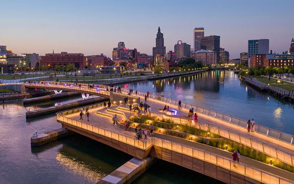 The Providence Riverwalk is the heart of the city’s urban revitalization, famous for hosting the "WaterFire" art installation where braziers burn on the water. The walk features Venetian-style footbridges and landscaped parks that connect the city's historic districts. It is a vibrant space for festivals, dining, and taking a scenic stroll along the water in the state's capital.