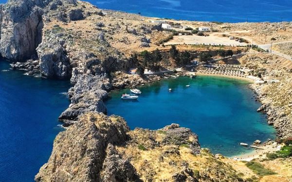 The Acropolis of Lindos is a spectacular archaeological site perched on a steep cliff overlooking the sea. It features the ruins of the Temple of Athena Lindia alongside a medieval castle built by the Knights. The combination of ancient Greek history and breathtaking coastal views, with the whitewashed village of Lindos below, makes it one of the most iconic sights on the island.