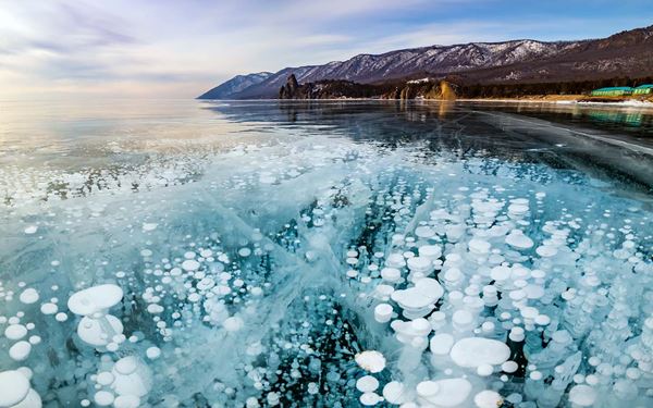 Lake Baikal in Siberia is the world’s deepest and oldest freshwater lake, containing 20% of the Earth's unfrozen surface water. Known as the "Pearl of Siberia," it is famous for its crystal-clear water and unique wildlife, including the Baikal seal. Whether frozen solid in winter or crystal blue in summer, the lake offers a serene and majestic natural experience in the heart of Russia.