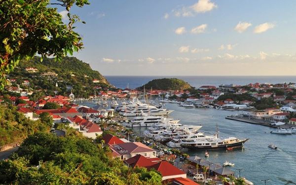 Gustavia is the charming capital of St. Barts, famous for its red-roofed buildings and harbor filled with luxury yachts. Visitors can explore historic forts like Fort Karl or shop at high-end boutiques. The town blends Swedish colonial history with French Caribbean elegance, offering a sophisticated yet relaxed atmosphere that has made it a favorite destination for the global elite.