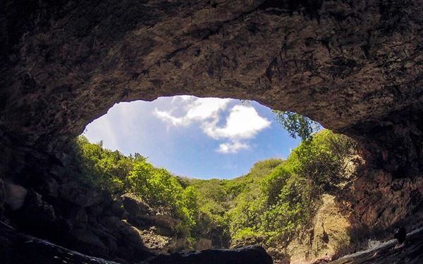The Grotto is a world-class dive site, a collapsed limestone cavern that connects to the ocean through three underwater tunnels. The deep blue, glowing water inside the cave creates a surreal and magical environment for experienced divers and snorkelers. It is a spectacular natural wonder that showcases the unique underwater geology of the Mariana Islands and the incredible clarity of the Pacific.
